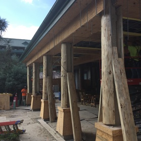 Peeled log post covers being installed